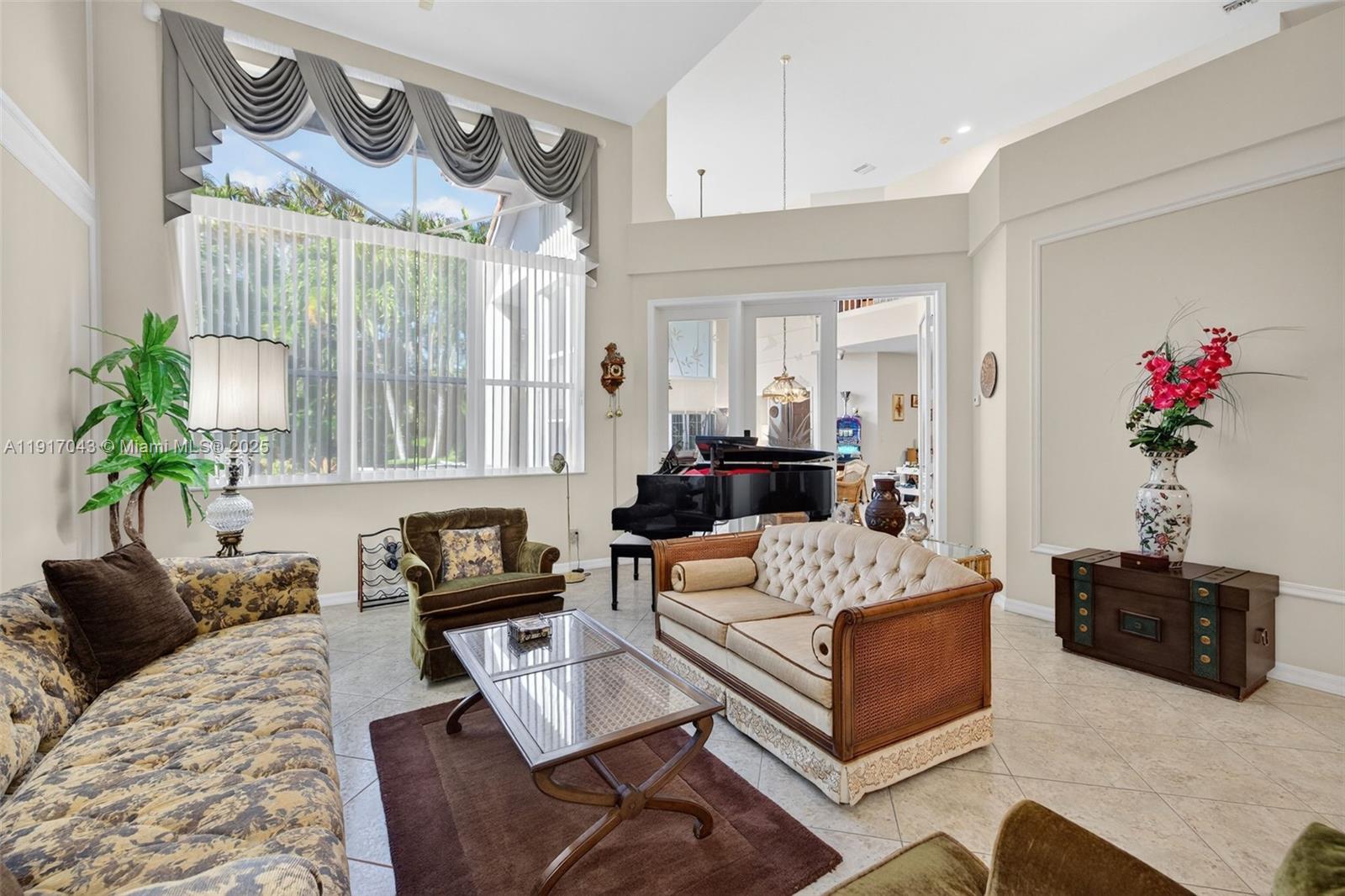 4123 West Lake Estates Drive Davie, FL 33328 - Photo 8 of 56 a living room with furniture and a chandelier