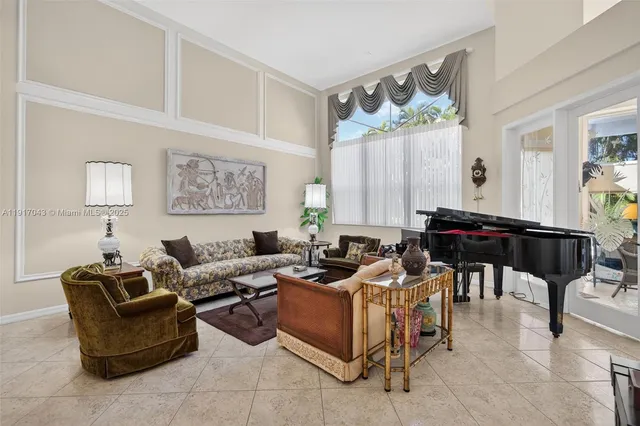 a living room with patio furniture and a flat screen tv