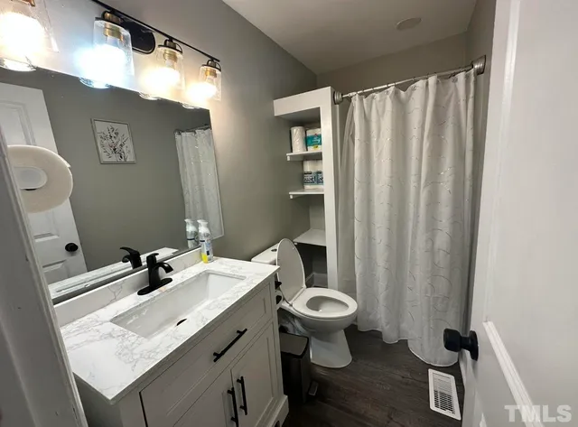 a bathroom with a sink toilet and shower