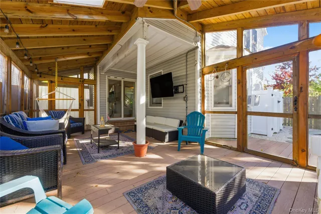 a living room with furniture a fireplace and a large window