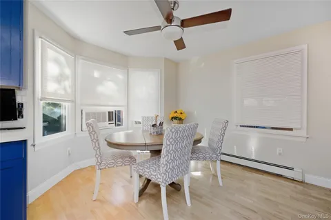 a dining room with furniture and window