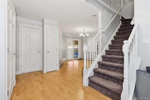 a view of entryway and hall with wooden floor
