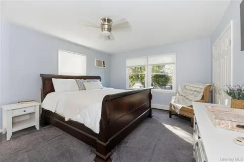 a bedroom with a bed couch and window