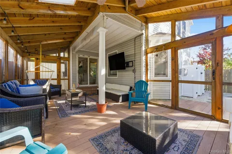 a living room with furniture a fireplace and a large window