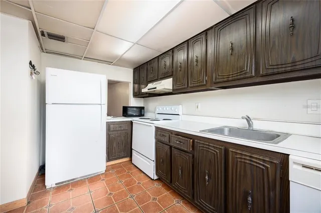 a kitchen with a sink stainless steel appliances and cabinets