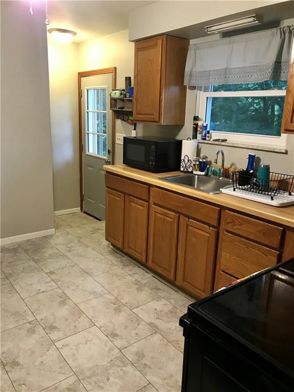 2884 South Bridge Road Washington, PA 15301 - Photo 13 of 17 a kitchen with stainless steel appliances a sink cabinets and wooden floor