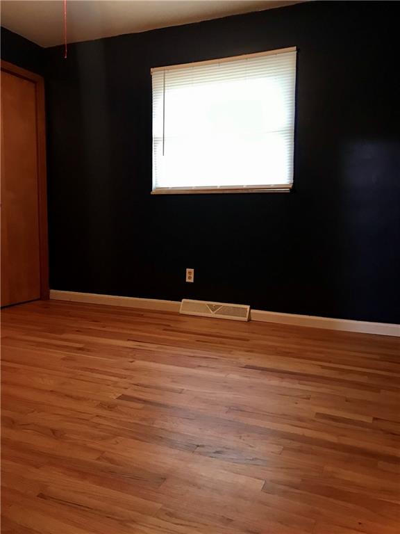2884 South Bridge Road Washington, PA 15301 - Photo 7 of 17 a view of an empty room with wooden floor and a window