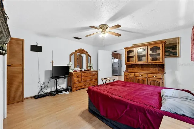 a bedroom with a bed and a flat screen tv