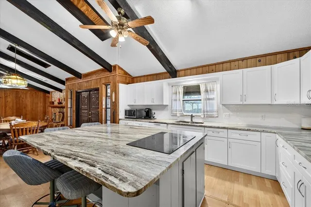 a kitchen with a table chairs refrigerator and cabinets