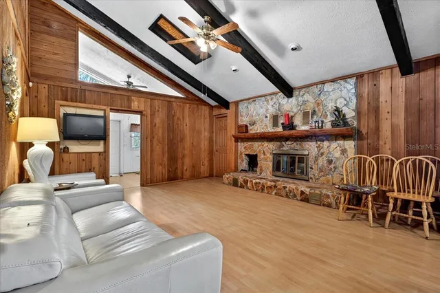 a living room with furniture and wooden floors