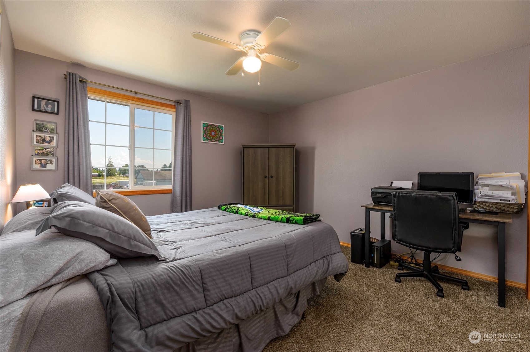 9216 Applegate Loop Southwest Rochester, WA 98579 - Photo 16 of 24 a bedroom with a bed desk chair and a window