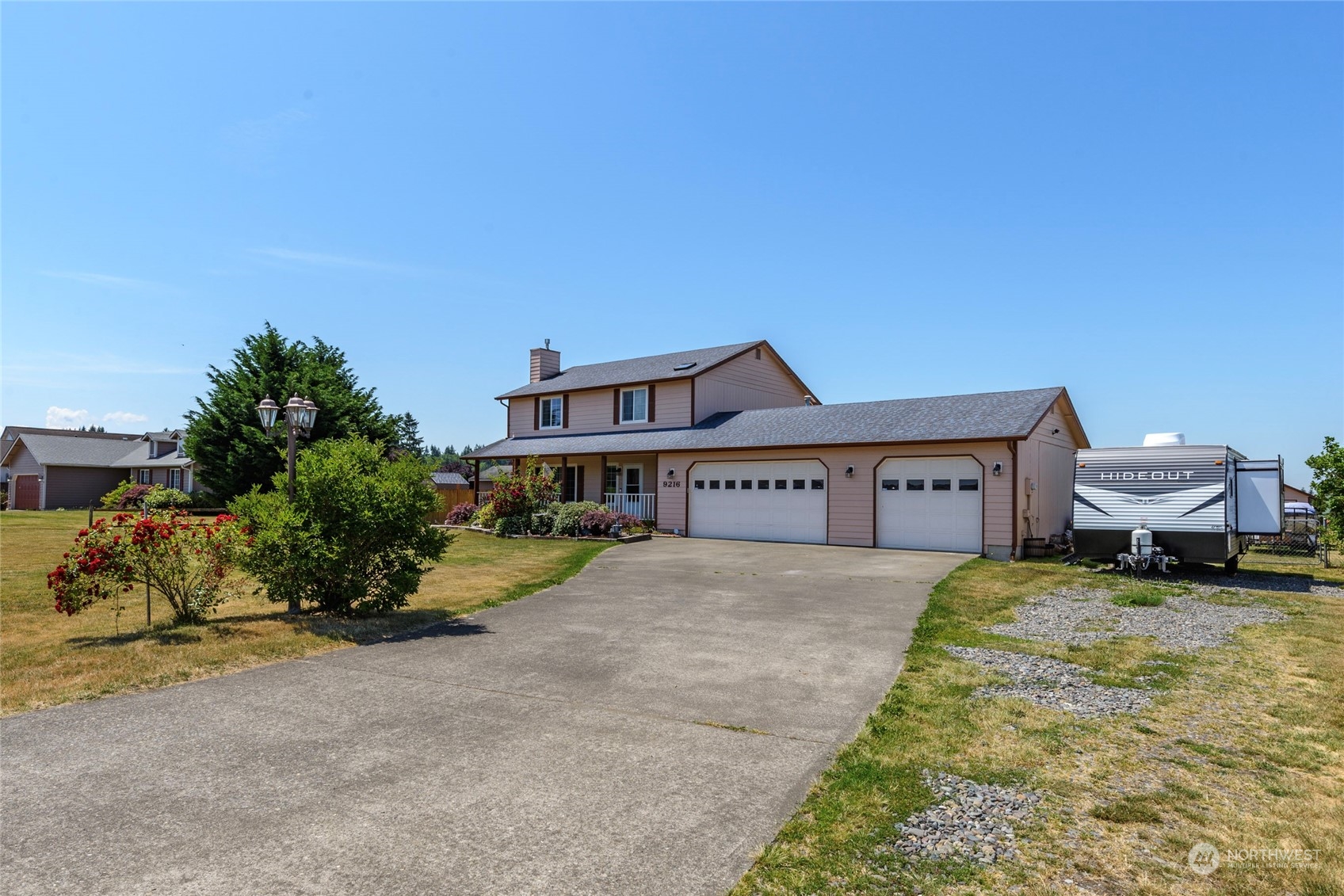 9216 Applegate Loop Southwest Rochester, WA 98579 - Photo 4 of 24 a view of a house with a yard and potted plants