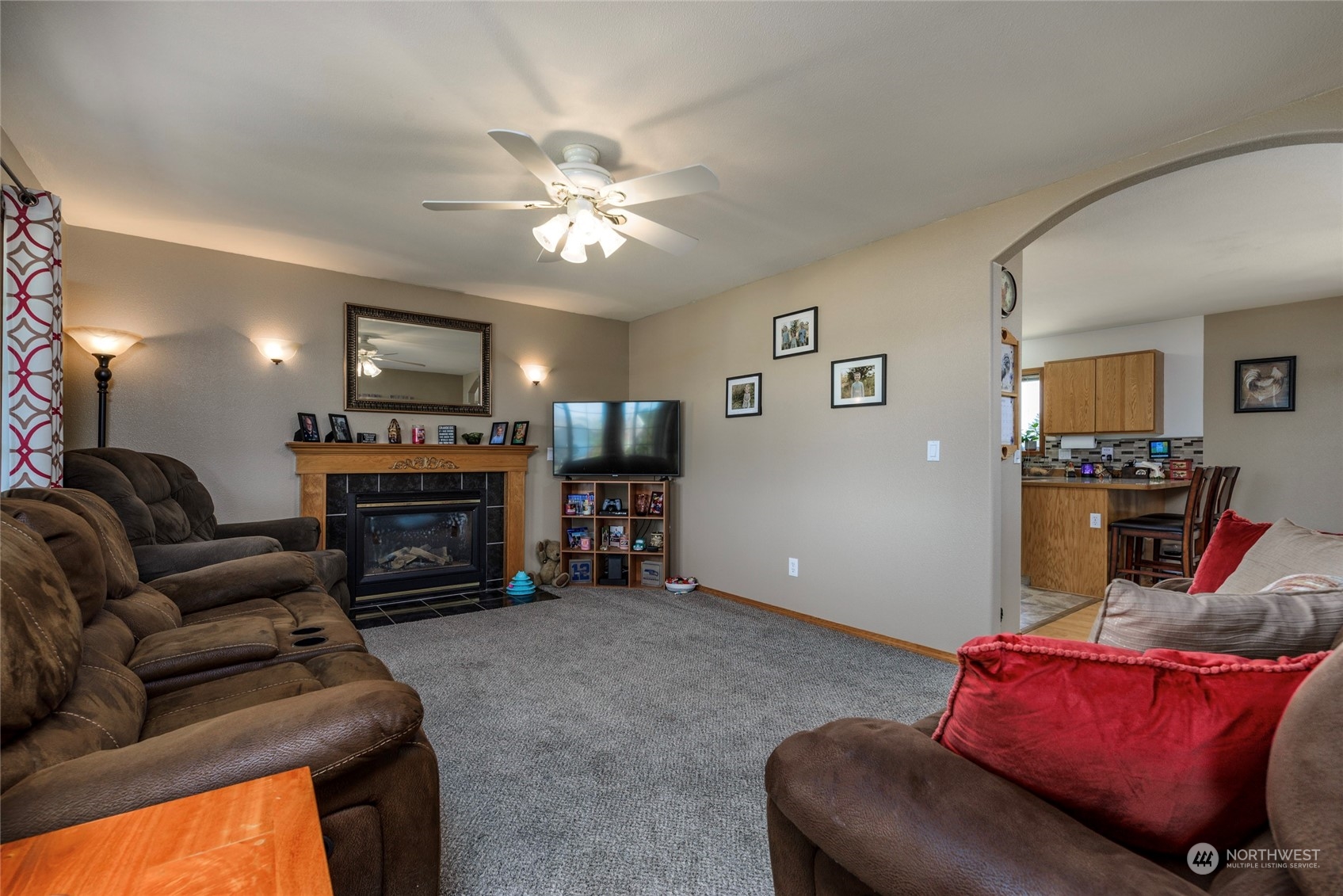 9216 Applegate Loop Southwest Rochester, WA 98579 - Photo 8 of 24 a living room with furniture a fireplace and a flat screen tv