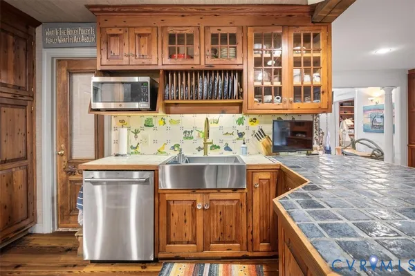 a kitchen with stainless steel appliances granite countertop a stove and a sink