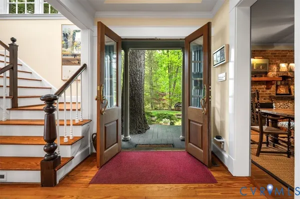a view of an entryway with wooden floor and door