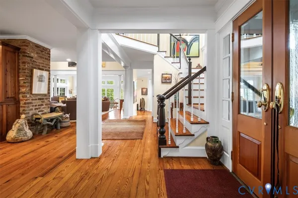 a view of an entryway with wooden floor and windows