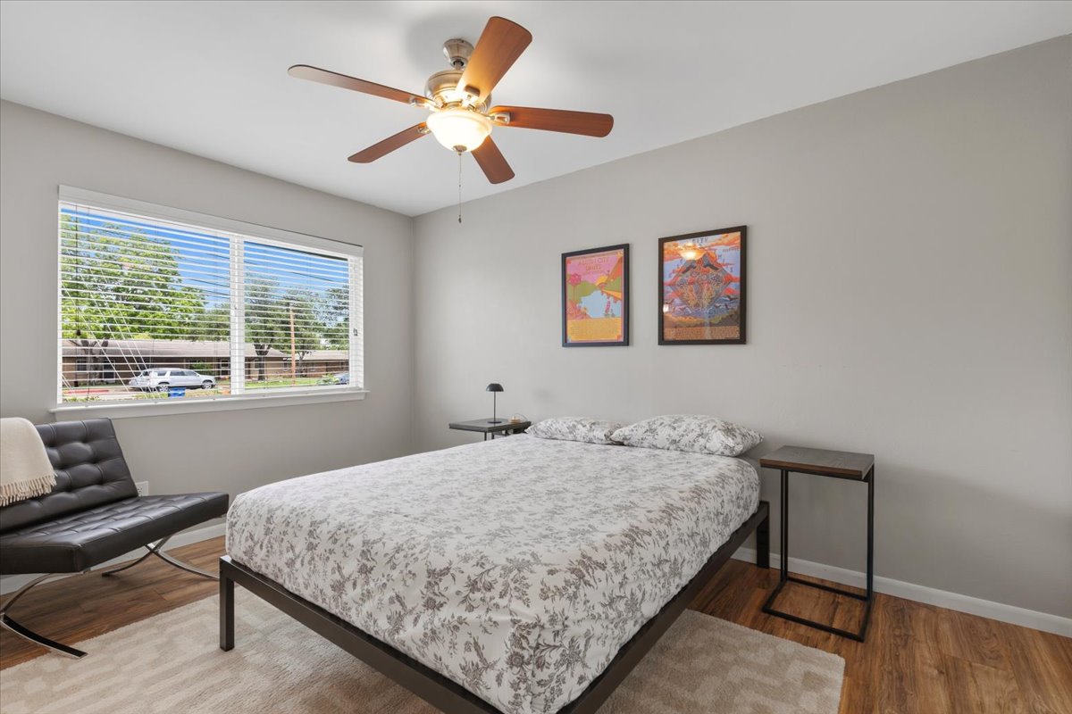 208 Skyloop Drive Austin, TX 78745 - Photo 17 of 34 Spacious secondary bedroom with updated flooring and abundant natural light.