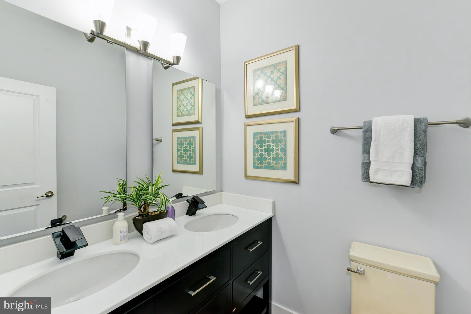 6729 Piney Branch Road Northwest Washington, DC 20012 - Photo 14 of 30 a bathroom with a sink a toilet and a mirror