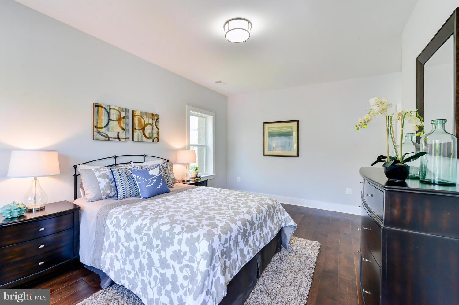 6729 Piney Branch Road Northwest Washington, DC 20012 - Photo 19 of 30 a bedroom with a large bed and a potted plant