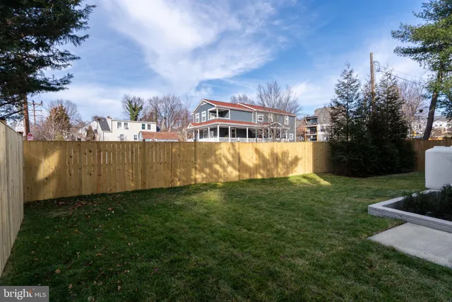 a view of a garden with a house in the background