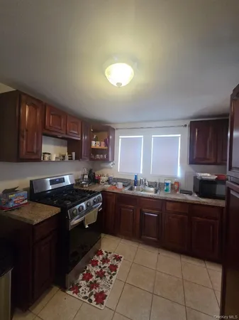 a kitchen with stainless steel appliances granite countertop wooden cabinets a stove top oven a sink and dishwasher