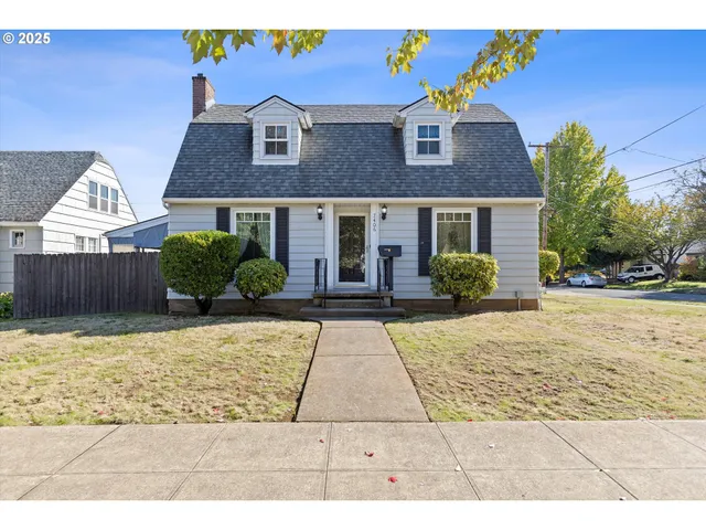 a view of brick house with a yard
