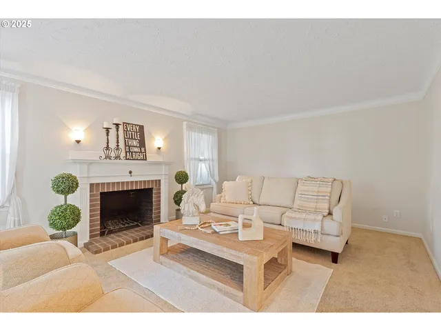 a living room with furniture a fireplace and a potted plant