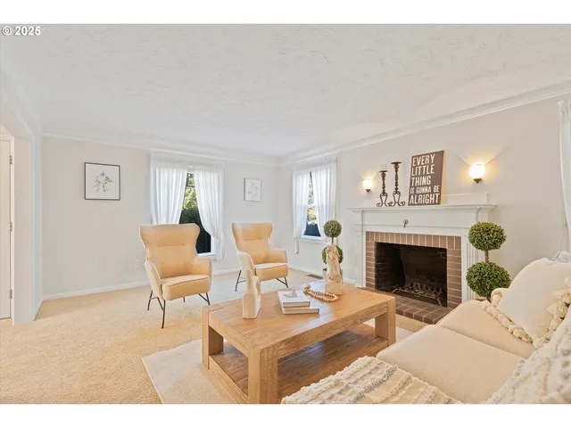 a living room with furniture a fireplace and a table