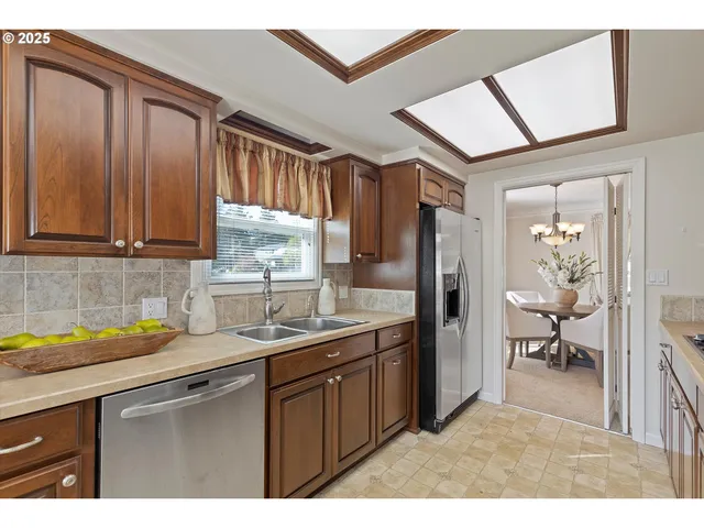 a kitchen with a sink window and cabinets