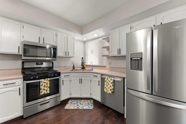 a kitchen with stainless steel appliances a refrigerator stove and microwave