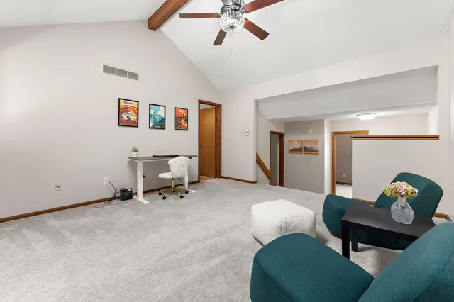 a living room with furniture and a chair