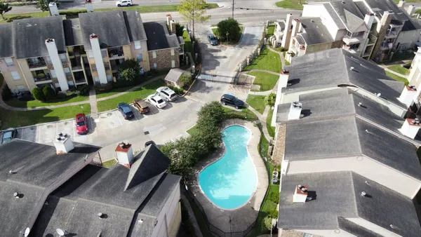 an aerial view of a house with a swimming pool