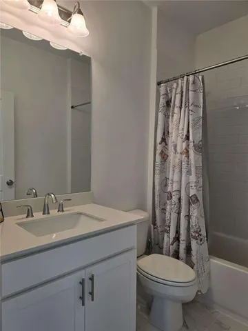 a view of a room with wooden floor and small window