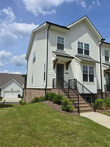 a front view of a house with a yard