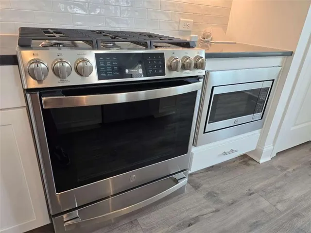 a stove top oven sitting inside of a kitchen