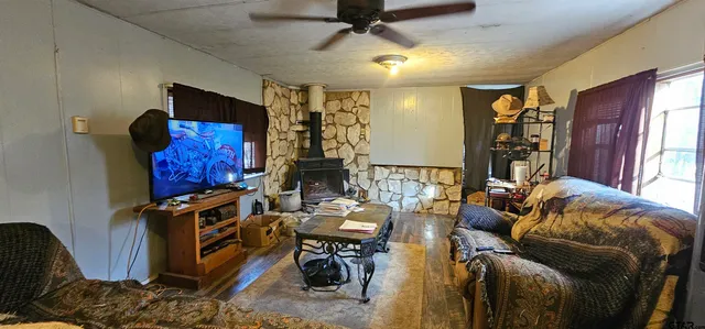a living room with furniture a flat screen tv and a window