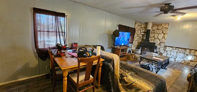 a view of a dining room with furniture and a window