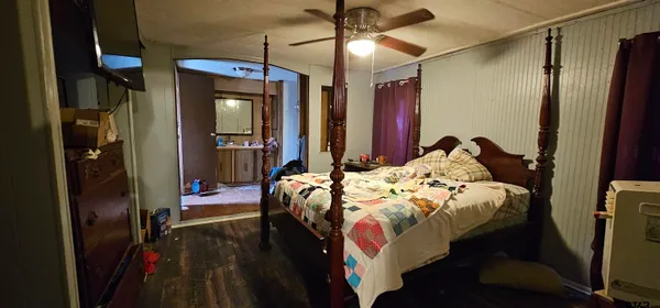 a bedroom with a bed and a mirror