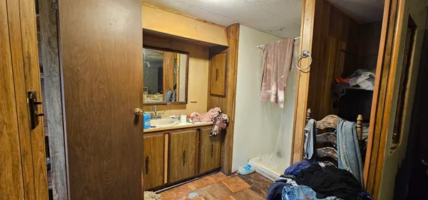 a bathroom with a sink a mirror and a shower