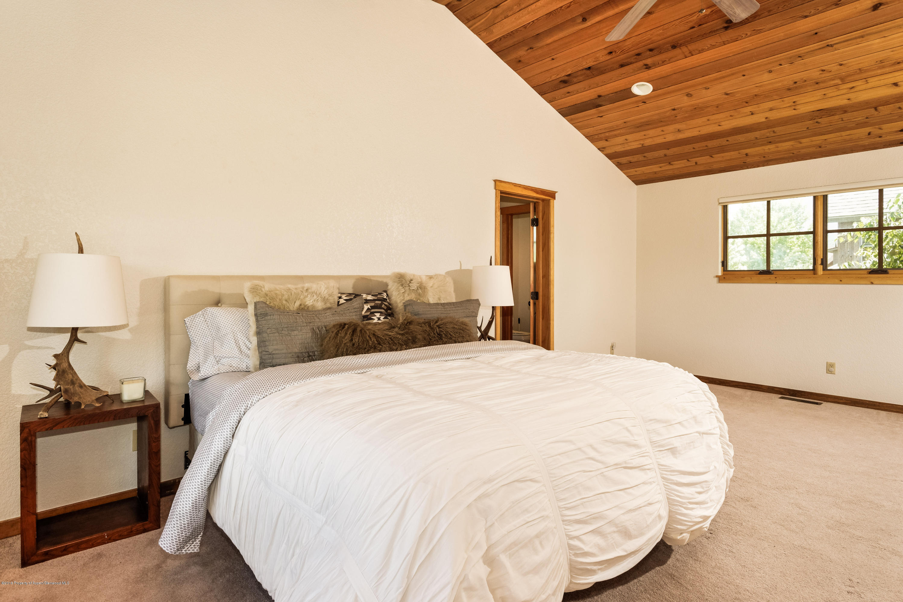 357 Sopris Circle Basalt, CO 81621 - Photo 13 of 24 a large bed sitting in a bedroom next to a window