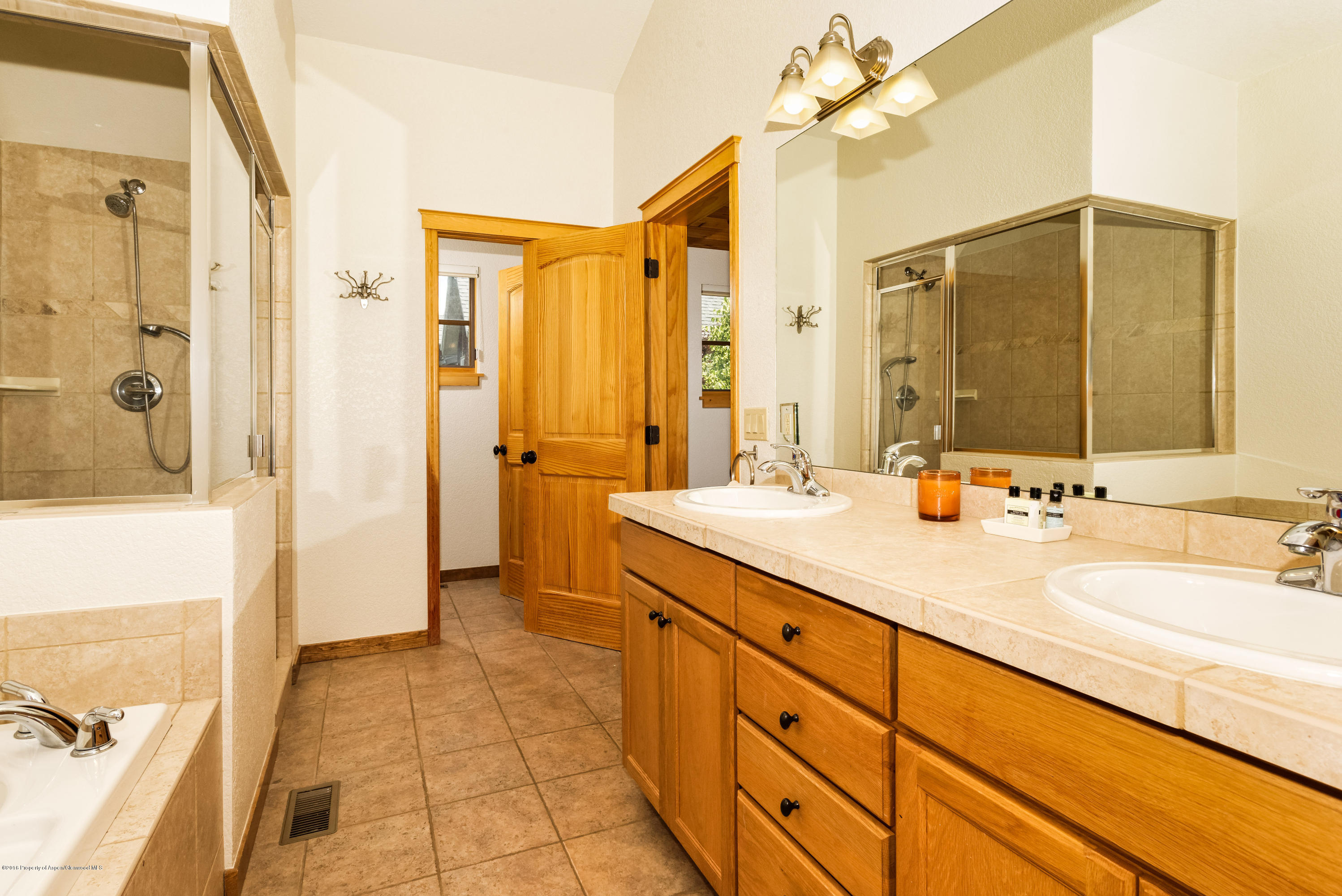 357 Sopris Circle Basalt, CO 81621 - Photo 16 of 24 a spacious bathroom with a double vanity sink a mirror and a shower