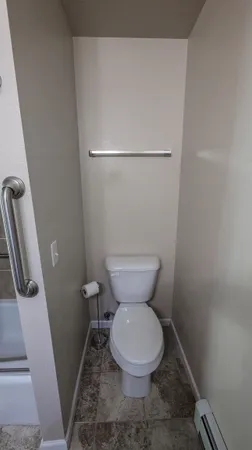 a white toilet sitting next to a sink