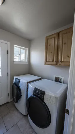 a utility room with a sink dryer and washer