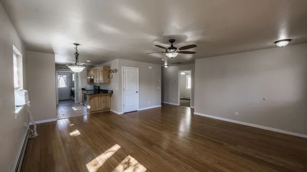 a view of a living room with wooden floor