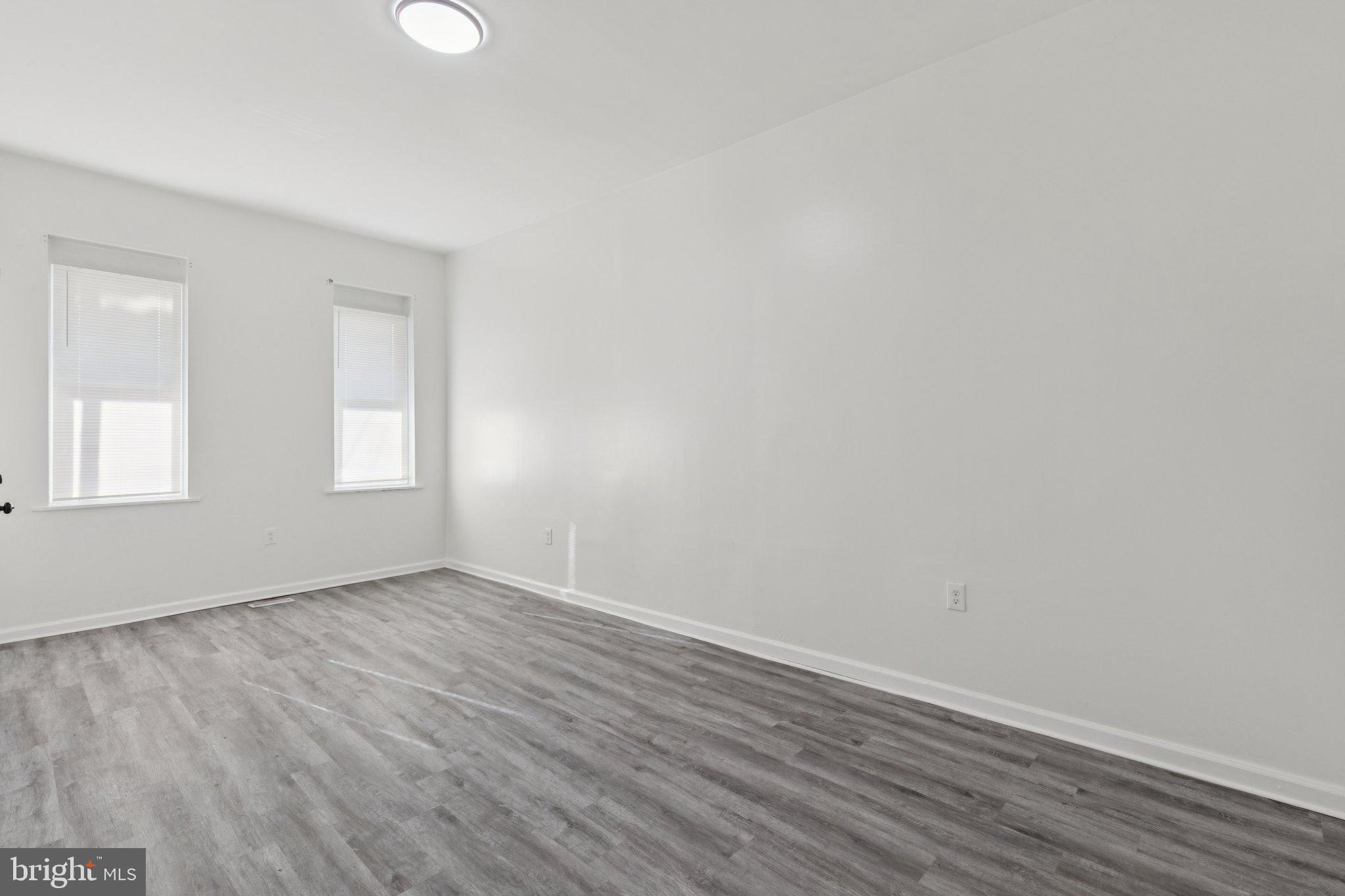 836 Haddon Avenue Camden, NJ 08103 - Photo 17 of 30 an empty room with wooden floor and windows