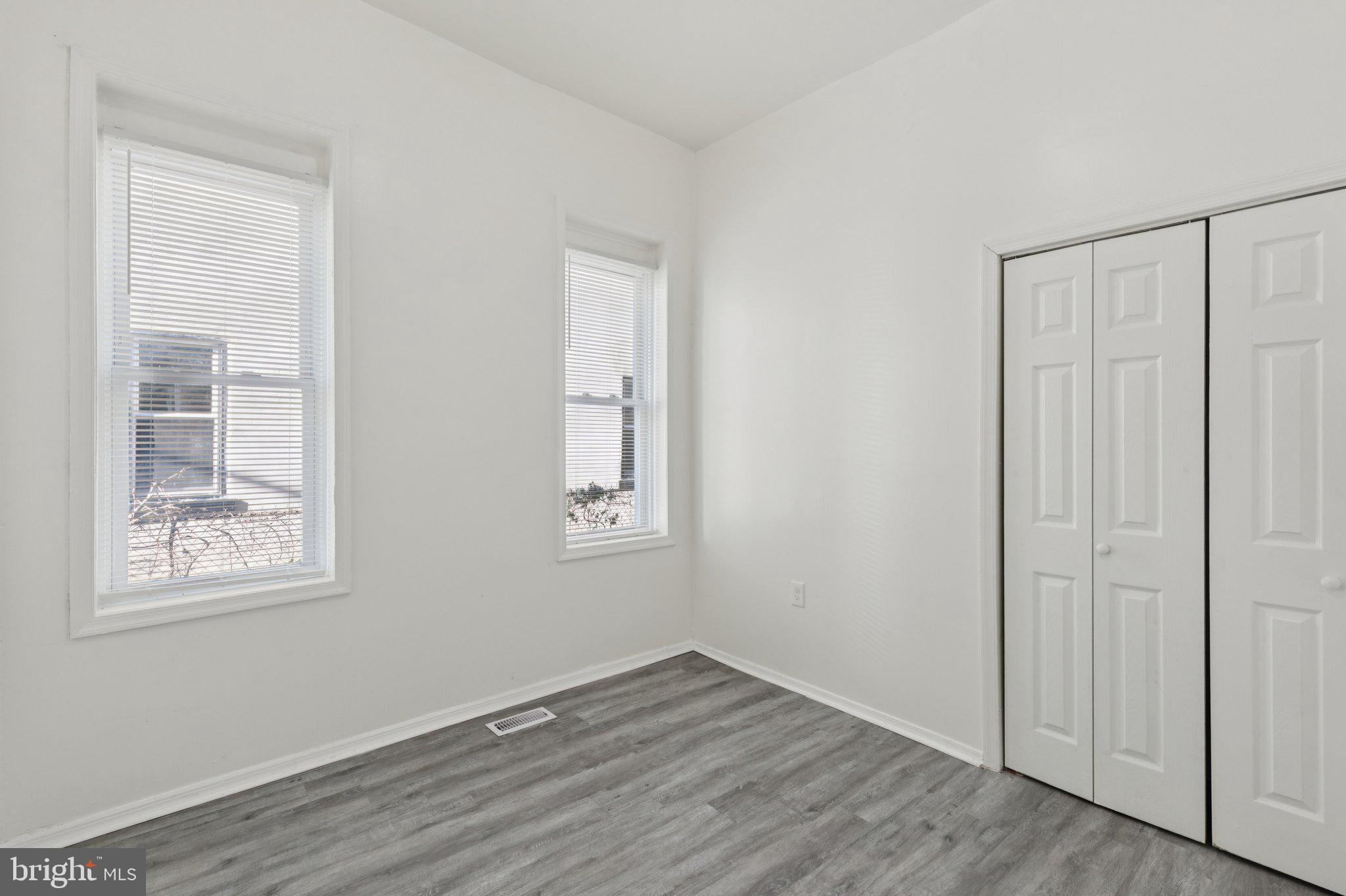 836 Haddon Avenue Camden, NJ 08103 - Photo 19 of 30 an empty room with wooden floor and windows