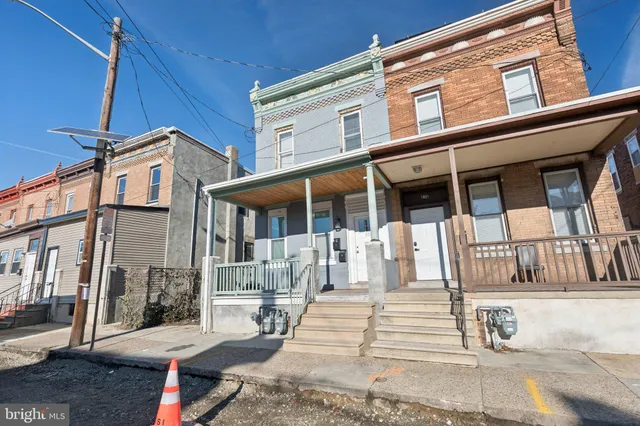 a front view of a house with a fountain