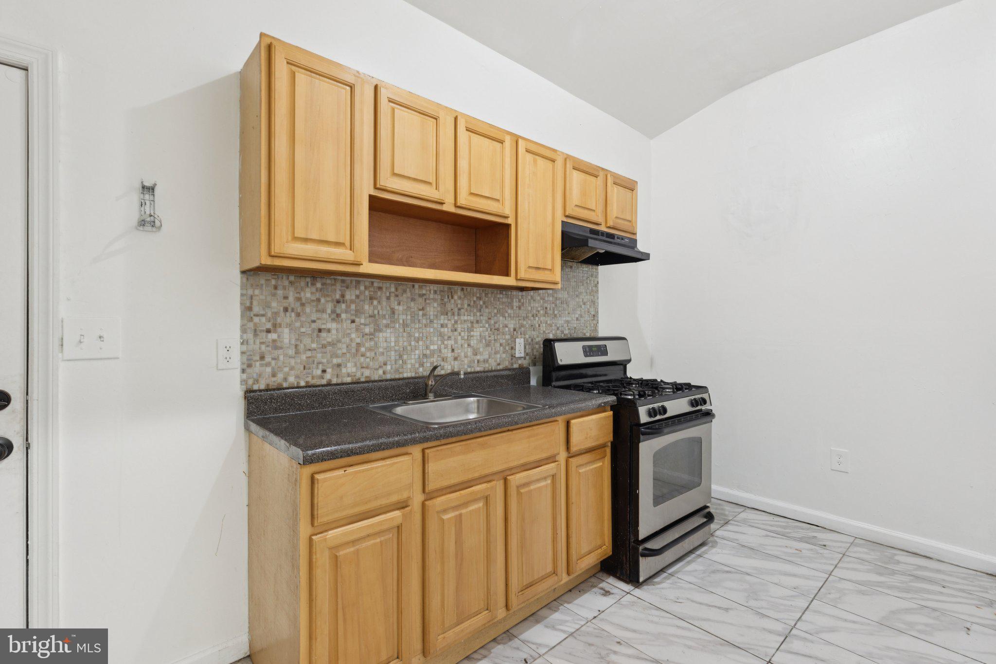 836 Haddon Avenue Camden, NJ 08103 - Photo 26 of 30 a kitchen with stainless steel appliances granite countertop a stove a sink and a microwave