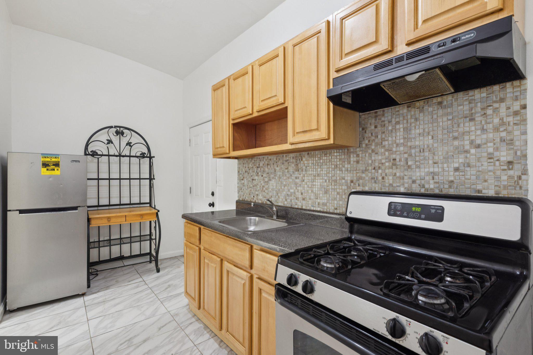 836 Haddon Avenue Camden, NJ 08103 - Photo 28 of 30 a kitchen with stainless steel appliances granite countertop a stove a sink and a granite counter tops