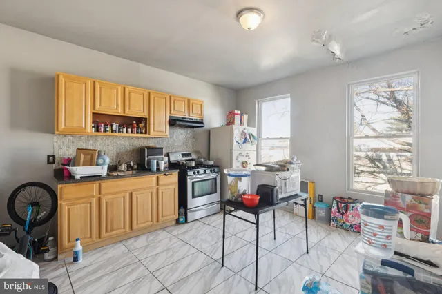 a kitchen with a stove and a refrigerator
